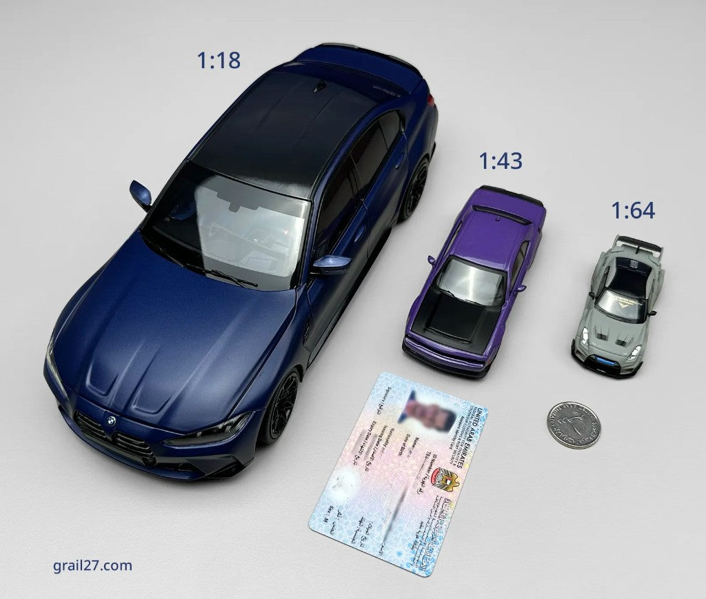 1:18, 1:43, and 1:64 scale model cars photographed next to a UAE Emirates ID and a 1 dirham coin